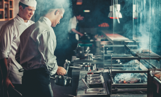 Chefs cooking in a kitchen having had restaurant operations streamlined