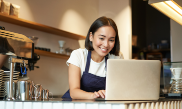 Lady In A Restaurant Reading How To Build A Restaurant Business Plan