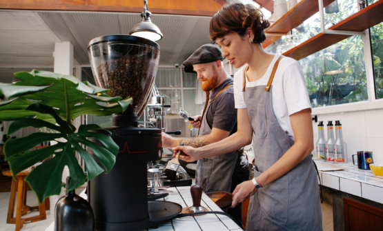 Two baristas working at the counter of a café