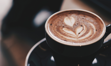 A coffee with a design placed on top.