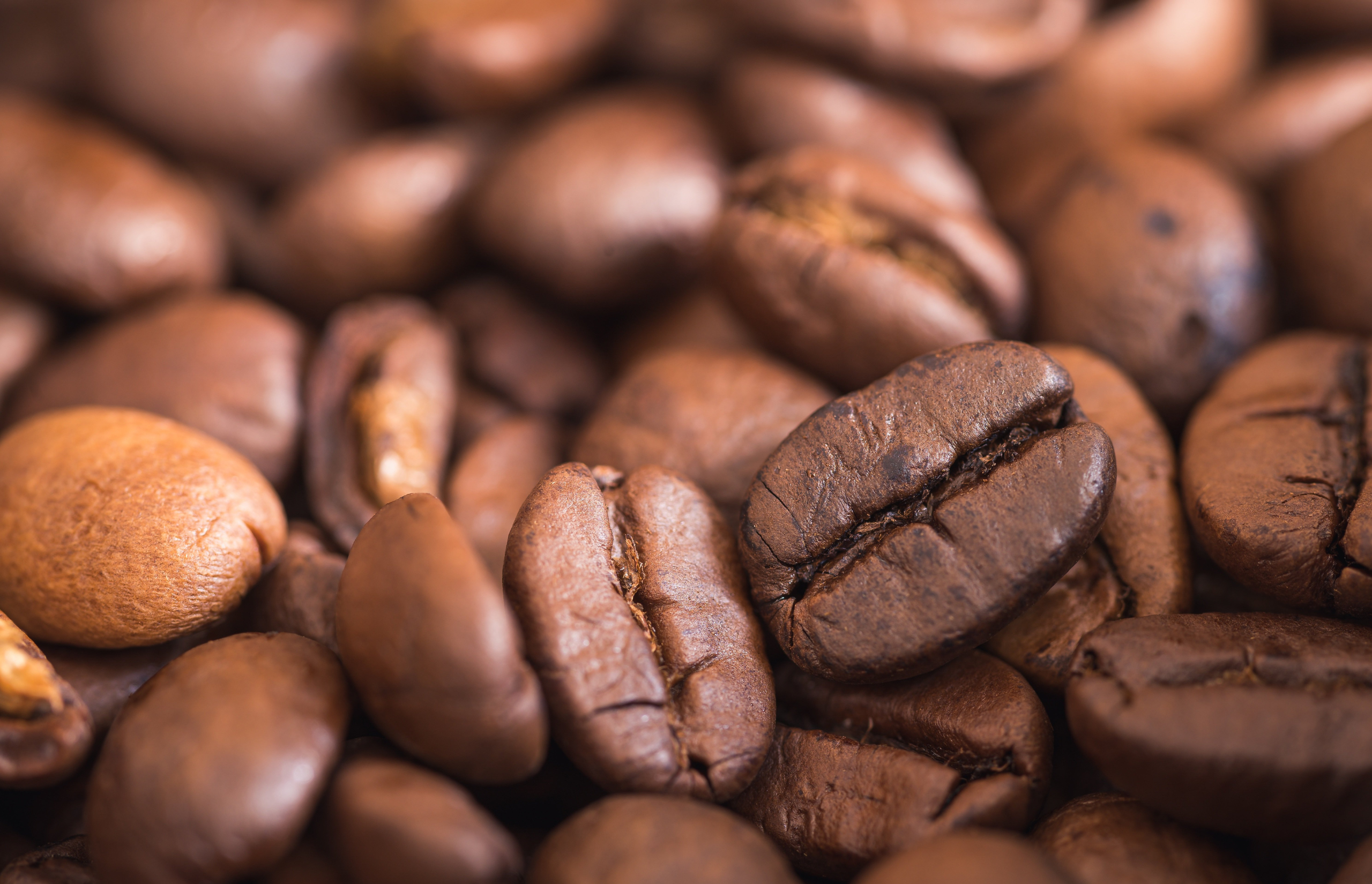 A close of up of roasted coffee beans, signifying that quality of product is key to cafe brand identity